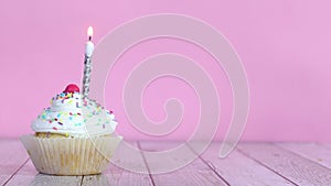 Lighting up candle on sweet testy cup cake with cream