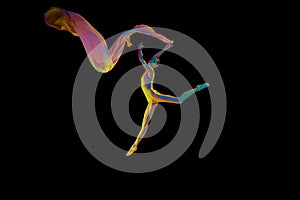 Lightness and freedom. Beautiful young woman, ballet dancer in motion with with flying silk fabric isolated on black