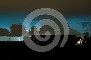 Lightning bolt strikes down behind a farm