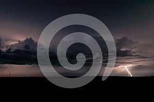 Lightning bolt strikes down to earth from a high based storm in North Dakota