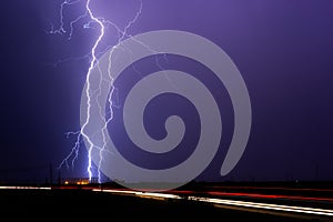 Lightning bolt strikes an electrical substation during a thunderstorm.