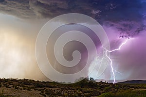 Lightning bolt strikes next to a microburst in a thunderstorm.