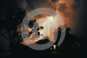 a lightning bolt strikes through the sky above a house