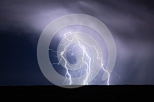 Lightning bolt striking in a storm. Thunderstorm in the night sky