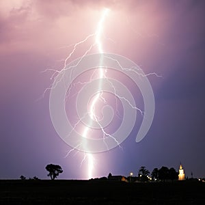 Lightning bolt at strom over village photo