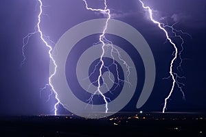 Lightning bolts strike from an electric summer storm.