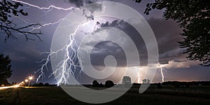 Lightning bolts striking at night photo
