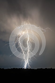 Lightning and clouds in night landscape storm