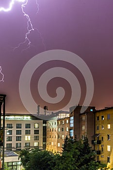 Lightning on the cloudy sky, urban city life with buildings, Austria