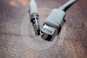 Lightning connector and 3.5mm standard jack lying together. New Apple connector concept
