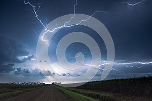 Lightning in the country over the field during a thunderstorm