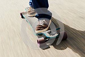 Lightning fast. Cropped shot of a man riding a skateboard at high speed.