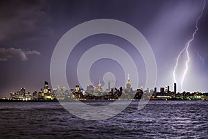 Lightning hitting a New York City skyscraper at twilight