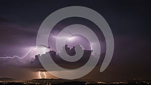 lightning over the city This is a photo of a lightning storm over a city at night with a purple sky and dark clouds.