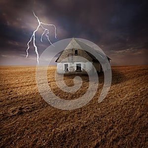 Lightning over farm in field