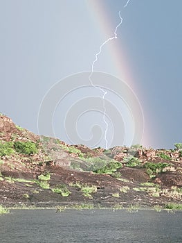 Lightning rain rainbow water Rocks