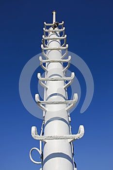 Lightning rod on ship against blue sky