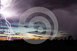 Lightning storm background with sunset sky and clouds.