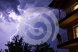lightning storm with observer on a balcony photo