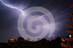 Lightning in a storm in old medival city with castle and a chapel (Kamnik, Slovenia)