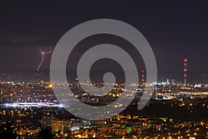 Lightning storm over city at night