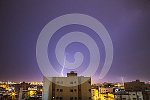 Lightning storm over city in purple light in jeddah al marwah