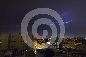 Lightning storm over city in purple light in jeddah al marwah