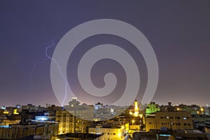 Lightning storm over city in purple light in jeddah al marwah