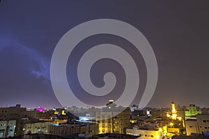 Lightning storm over city in purple light in jeddah al marwah