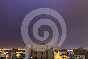 Lightning storm over city in purple light in jeddah al marwah