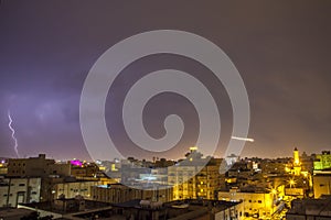 Lightning storm over city in purple light in jeddah al marwah