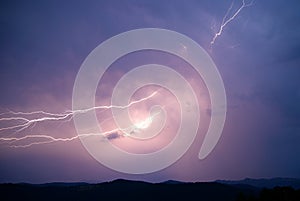 Lightning strike on the dark cloudy sky