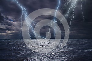 Lightning strike over the ocean. Bolt of lightning over stormy dark sea during a thunder-storm
