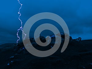 Lightning strike over rock formation