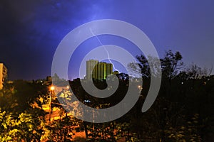 Lightning strikes a high-rise building in the night