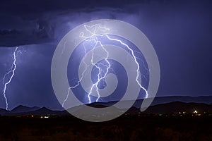 Lightning strikes a mountain in a summer storm