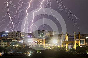 Lightning strikes over the city buildings