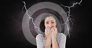 Lightning strikes and scared afraid woman biting nails