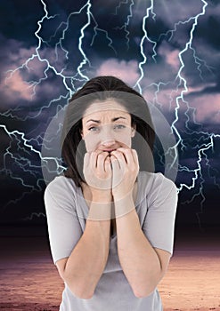 Lightning strikes and scared afraid woman biting nails