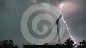 Lightning strikes several times in one place, construction crane, slow motion