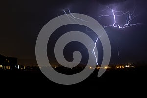 Lightning strikes during a thunderstorm in an urban area