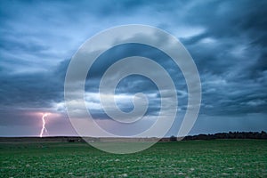 Lightning striking the ground below a spring thunderstorm