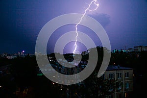 Lightning thunderstorm over the city buildings
