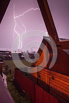 Lightning thunderstorm storm over the village at night