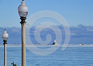 Lightpost in foreground with cloudscape over horizon of Lake Michigan on a freezing January morning with frozen lake