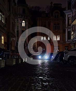 The lights of the car in the evening in Vozdvizhenska street