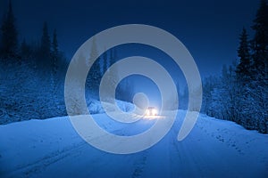 Lights of car and winter road