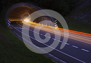 Lights of the cars on the road to the tunnel.