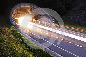 Lights of the cars on the road to the tunnel.