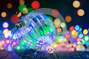 Lights of christmas garlands and decorative glass ball on dark d